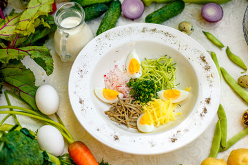 Vegetarian salad with onion radish and egg on a white plate