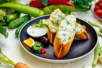appetizing garlic bread with cheese and fresh vegetables