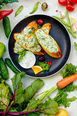 appetizing garlic bread with cheese and fresh vegetables