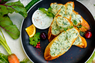 appetizing garlic bread with cheese and fresh vegetables