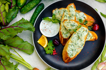 appetizing garlic bread with cheese and fresh vegetables
