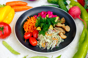 vegetarian dish with vegetables. Tomatoes, carrots, cabbage, mushrooms and beets