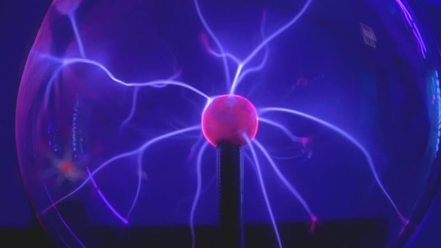 Plasma Globe. Voltage Electricity Radiates In This Pink And Purple Science Experiment. Slow Motion.