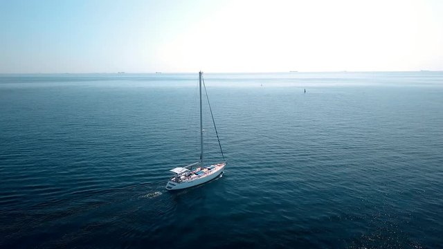 Yacht sailing on opened sea. Sailing boat. Yacht from drone. Yachting video. Yacht from above. Sailboat from drone. Sailing video. Yachting at windy day. Yacht. Sailboat.