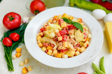 fresh salad with chicken, cheese, rusks, lettuce and tomatoes