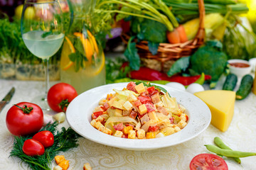 fresh salad with chicken, cheese, rusks, lettuce and tomatoes