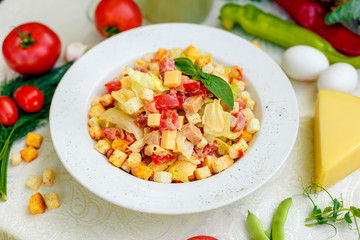 fresh salad with chicken, cheese, rusks, lettuce and tomatoes