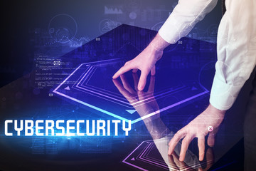 Hand touching digital table with CYBERSECURITY inscription, new age security concept