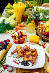 fried chicken grilled with onion and hot pepper on a decorated table