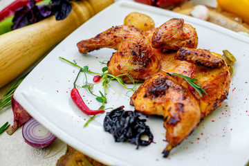fried chicken grilled with onion and hot pepper on a decorated table