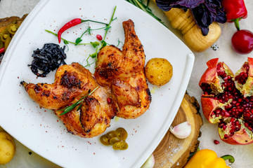 fried chicken grilled with onion and hot pepper on a decorated table