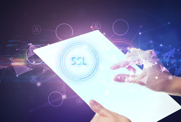 Hand holdig futuristic tablet with SSL inscription, modern technology concept