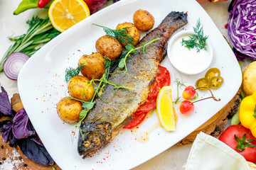 Grilled trout with potato sauce and tomato sauce and jalapeno