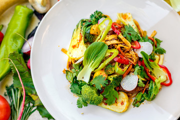 delicious salad with broccoli meat greens with pepper and vegetables, on a decorated table