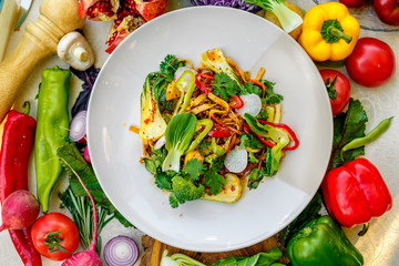 delicious salad with broccoli meat greens with pepper and vegetables, on a decorated table