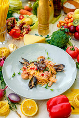 Pasta with seafood, octopus, shrimps and mussels on a decorated table