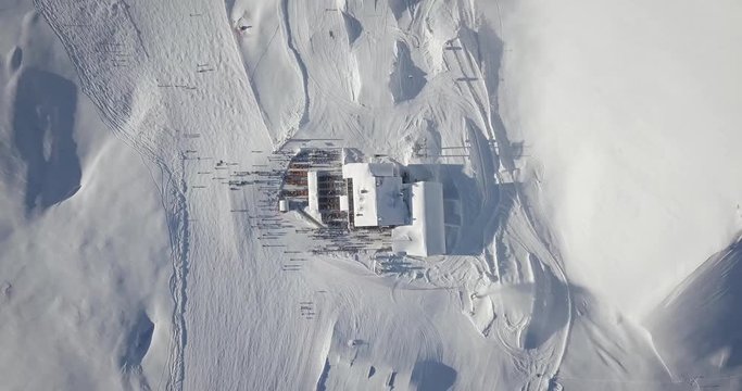 Mountain huts, Birds eye view Drone view of the snow-capped mountains, ski resort in Dolomite Alps with snow in Madonna di Campiglio, Val Rendena, Italian Alps, Italy
