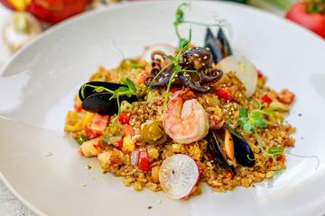 ice risotto with seafood, mussels, shrimps and vegetables, healthy food
