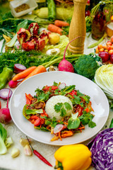 Thai meat with vegetables on a decorated table in a white plate