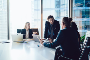 Successful male and female crew of financial experts have cooperation meeting at office table for discussing project planning, professional executive managers consultancy and brainstorming in firm