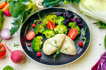 diet food, boiled chicken breast with broccoli and tomatoes on a decorated table