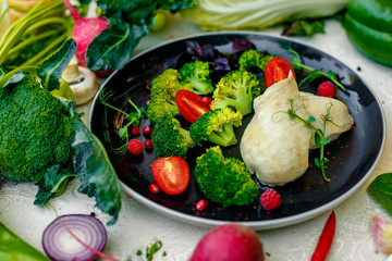 diet food, boiled chicken breast with broccoli and tomatoes on a decorated table