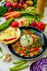 Mexican food, fajitos with vegetables, wheat cake and hot pepper on the table decorated with vegetables