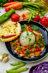 Mexican food, fajitos with vegetables, wheat cake and hot pepper on the table decorated with vegetables