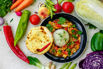 Mexican food, fajitos with vegetables, wheat cake and hot pepper on the table decorated with vegetables