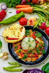 Mexican food, fajitos with vegetables, wheat cake and hot pepper on the table decorated with vegetables