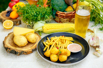 Cheese balls with crispy fresh French fries with sauce on a decorated table