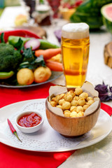 fried dumplings in wooden utensils with hot pepper and beer