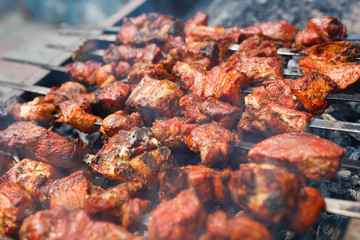 Tasty, juicy, delicious grilled skewers are fried on the grill. Fragrant pieces of red meat are put on a skewer and fried on the grill.