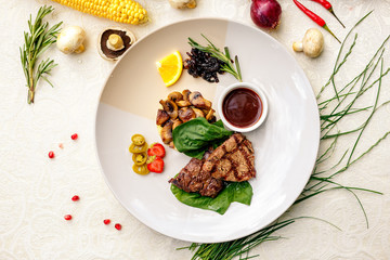 pieces of grilled meat with mushrooms and mashed potatoes