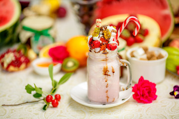 Crazy shake on top with a strawberry marmalade and candy and marmalade bears on a bright colored background