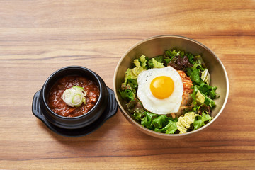fried egg, with vegetable salad Is a rice and  Strong miso Put in a Brass bowl placed on a wooden table.