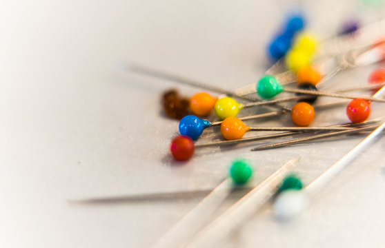 Close-up Of Multi Colored Straight Pins On Table