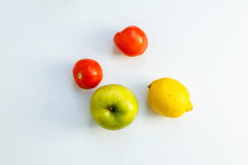 isolated apple lemon and tomatoes
