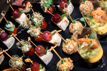 Assorted meat, vegetable, cheese canapes on skewers for the whole frame. horizontal frame