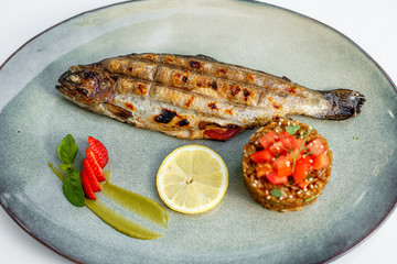 fried trout with lemon and garnish