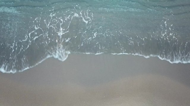 Aerial birds eye view looking down at sea waves crashing down. Green and blue sea top view drone, drone footage , 4k 