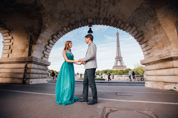 A romantic couple of lovers meet near the Eiffel tower.Paris, France