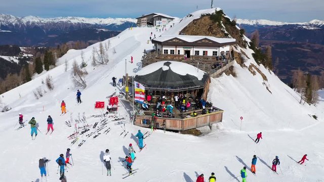 Aerial View of Nassfeld Ski Resort in Austrian province of Carinthia with Skiers on slopes and Apres Ski Party