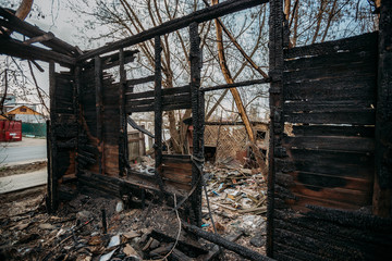 Consequences of fire. Completely burnt wooden house