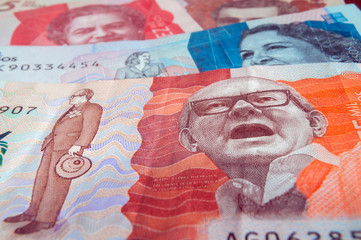 Twenty thousand Colombian pesos banknote in the foreground and others of two, five and ten thousand in the background. Colombian banknotes, Colombian money