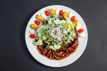 Mix of five types of lettuce (iceberg, batavia, spinach, arugula, lollo rossa) and crispy cucumbers in a dressing from Greek yogurt