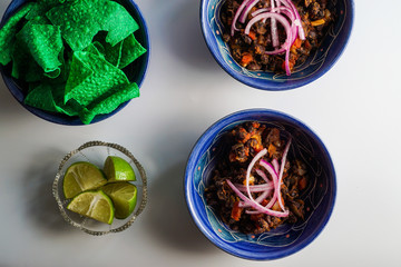 Fototapeta premium Black bean chili with condiments and chips