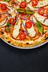 pizza with cheese and chicken with tomatoes