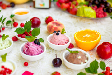 ice cream with fruits and different flavors (pistachio, chocolate, vanilla, cream)