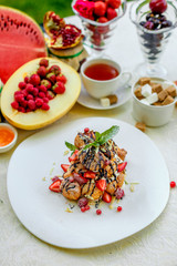 Krekembush - an elegant French profiterole cake topped with chocolate and nuts